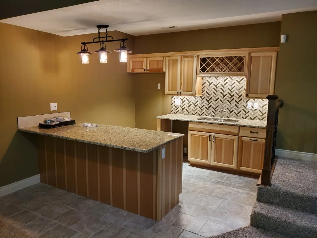 A small kitchen with a fireplace and cabinets.