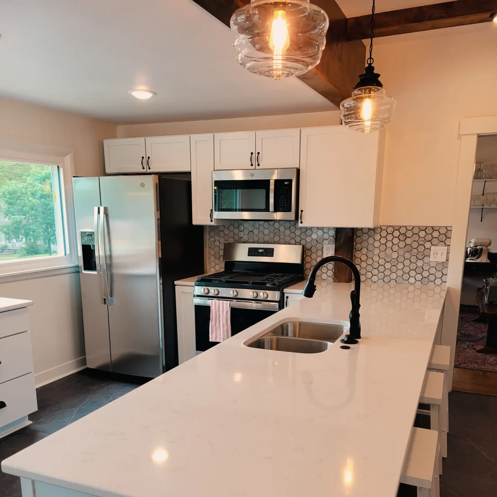 A kitchen with white cabinets and stainless steel appliances.