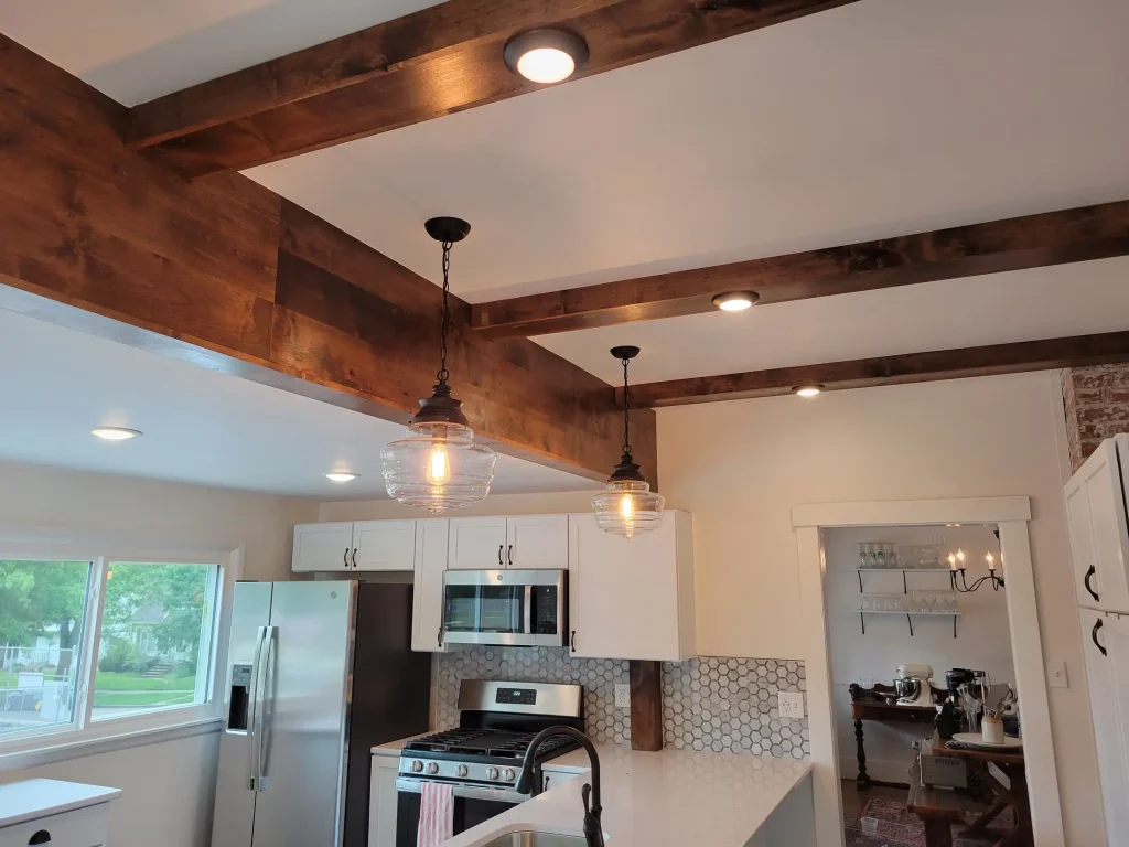 A kitchen with wood beams in the ceiling.