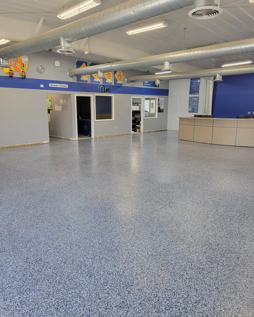 A large room with a blue floor and white walls.