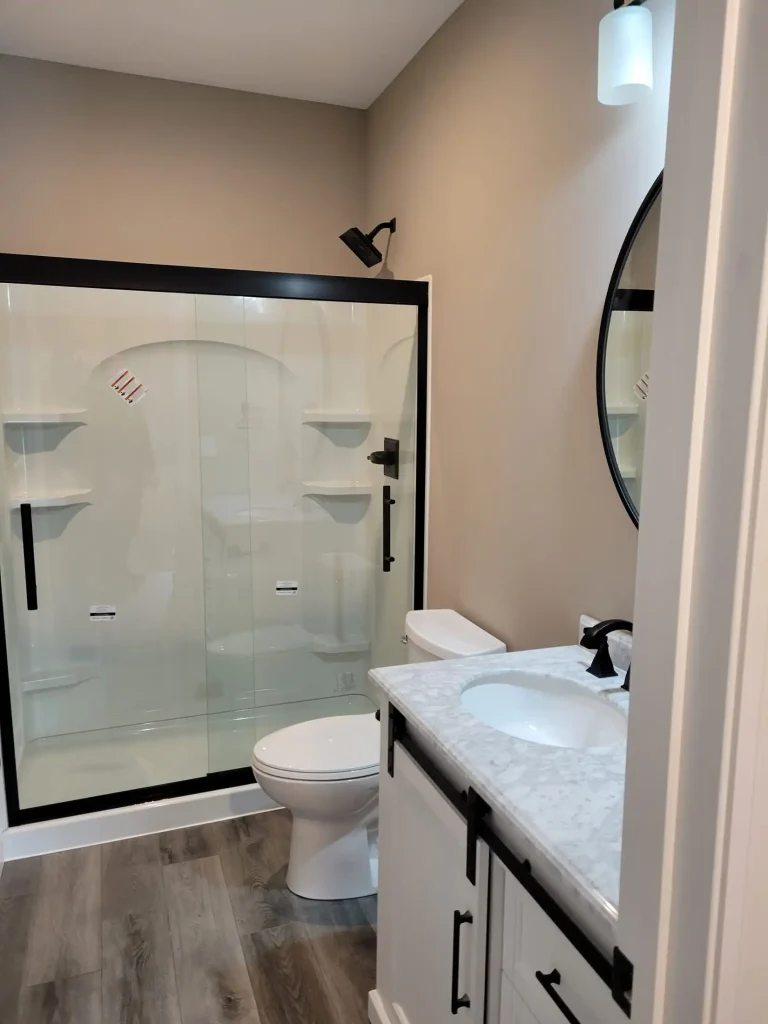 A white bathroom with a glass shower stall.