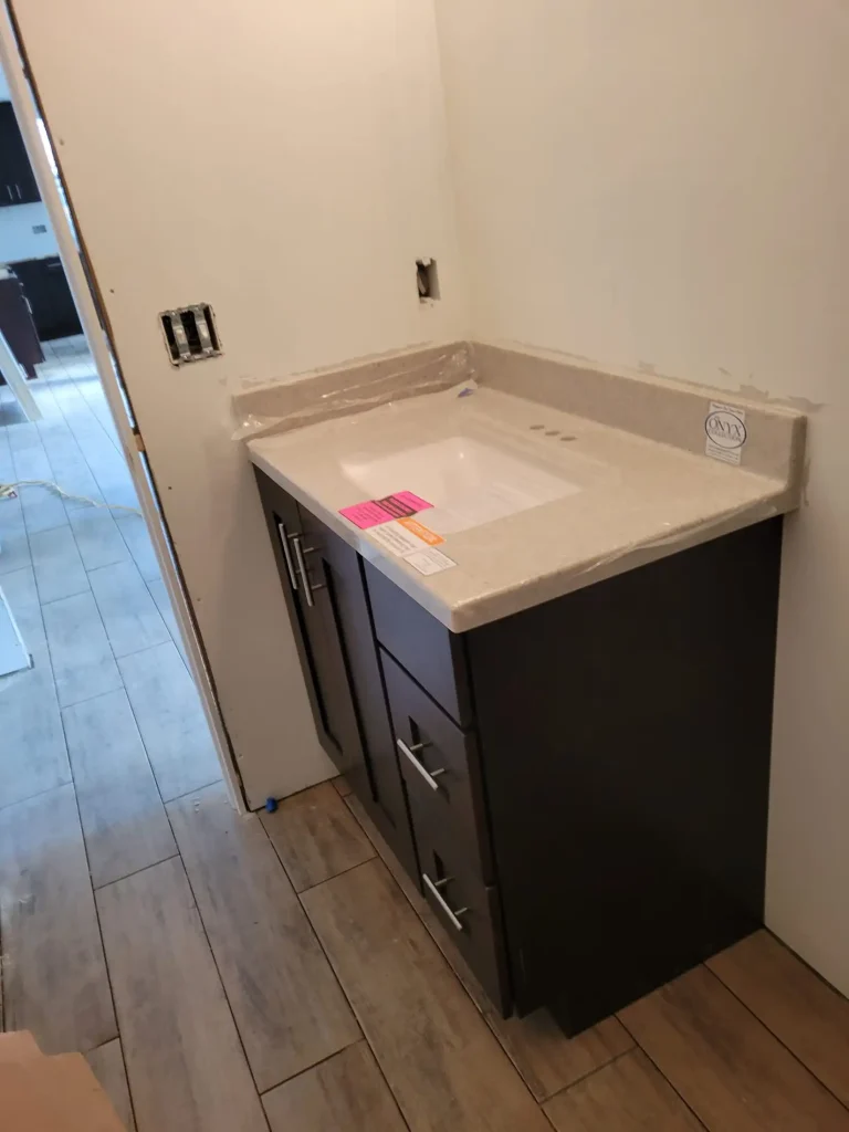 A bathroom sink in an unfinished room.