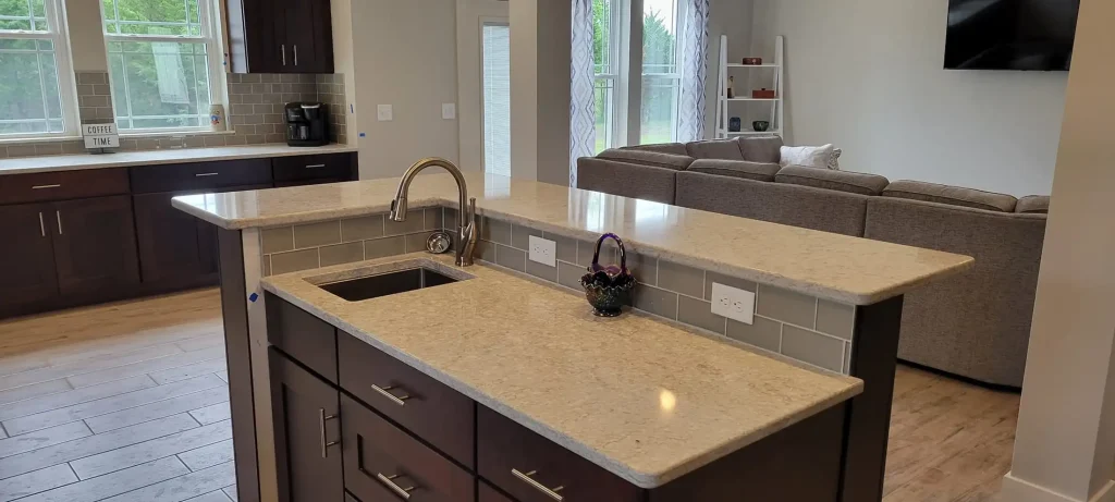 A kitchen with a granite counter top and stainless steel appliances.