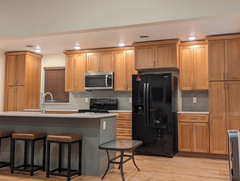 A kitchen with wood cabinets and stainless steel appliances.