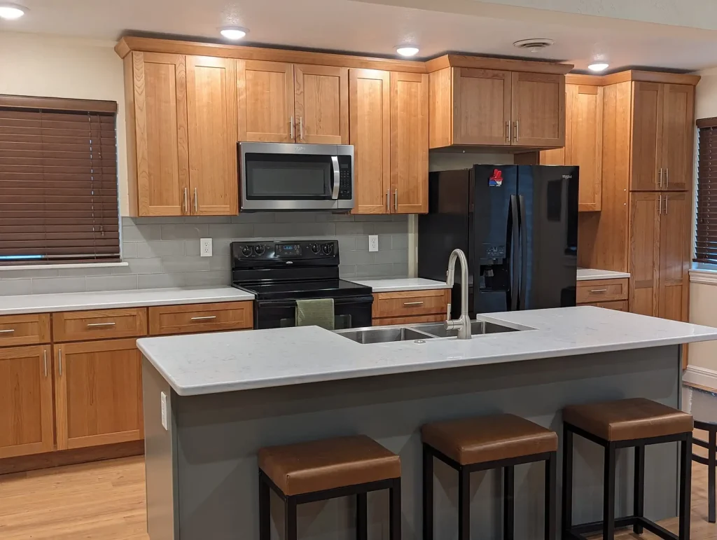 A kitchen with wood cabinets and stainless steel appliances.