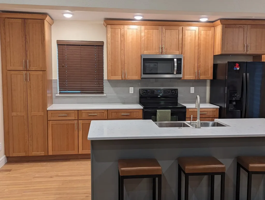 A kitchen with wood cabinets and stainless steel appliances.