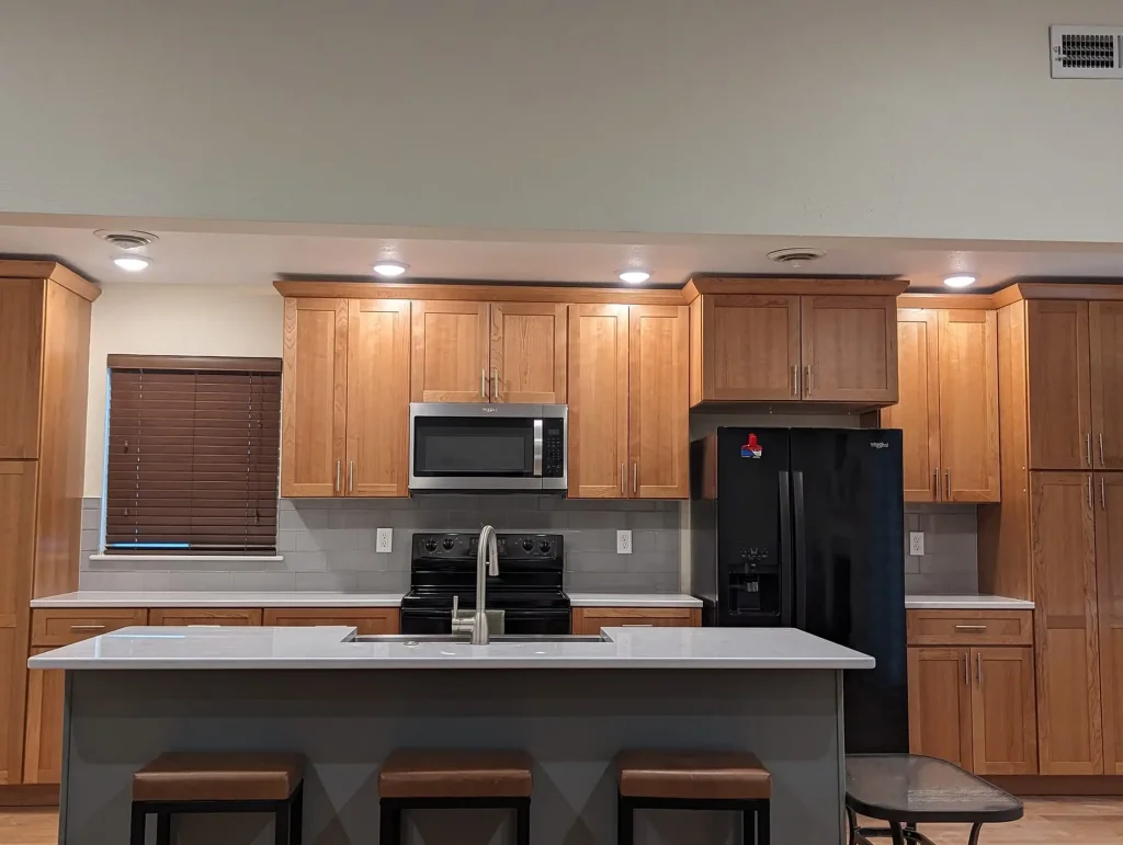 A kitchen with wood cabinets and stainless steel appliances.