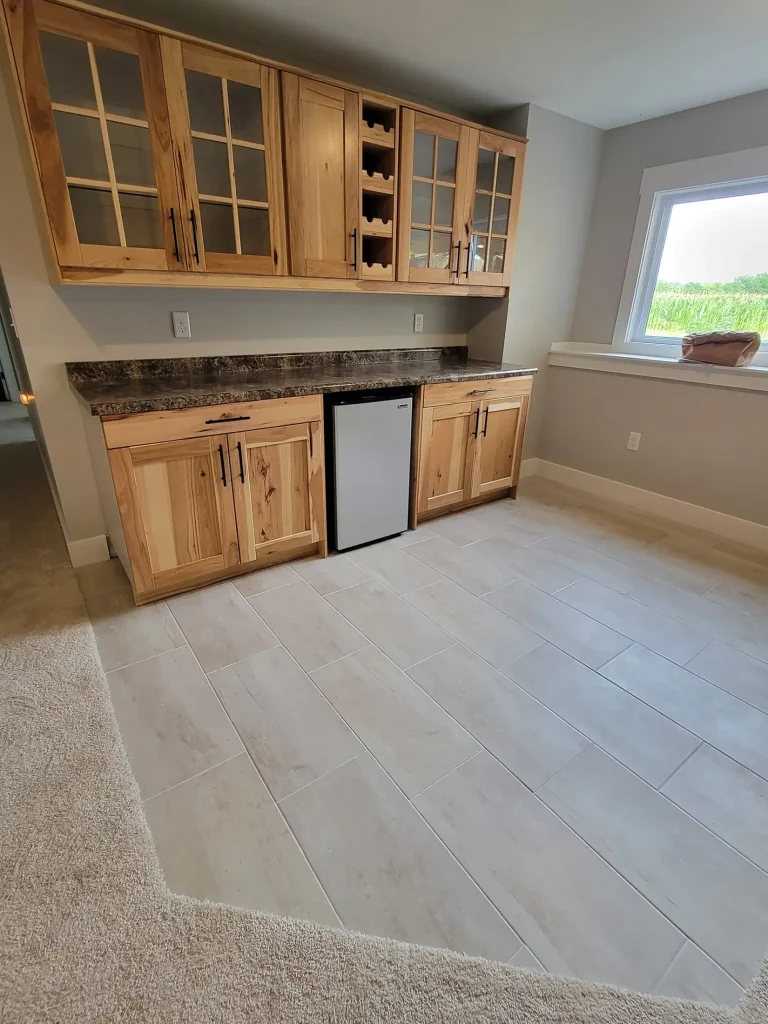 A kitchen with white cabinets and a refrigerator.