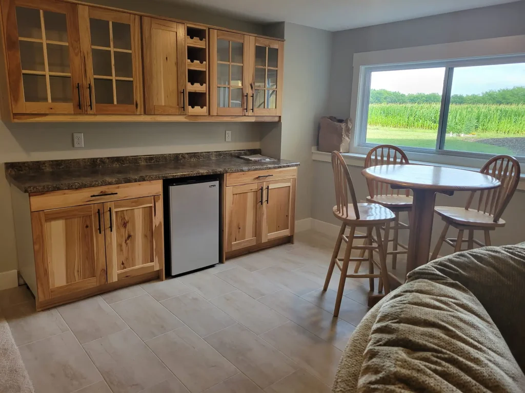 A kitchen with a table and chairs and a refrigerator.